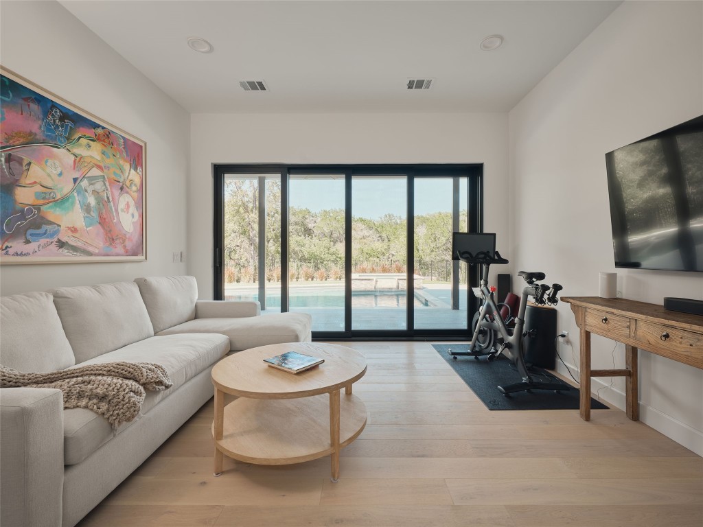 3214 Smoky Ridge, Unit LOT A Austin, TX 78730 - Photo 20 of 32 a living room with furniture a flat screen tv and a large window