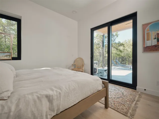 a bedroom with a large bed and a large window