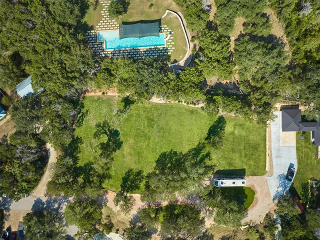 an aerial view of a house with a yard
