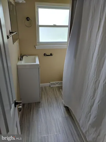 a view of a room with wooden floor and a window