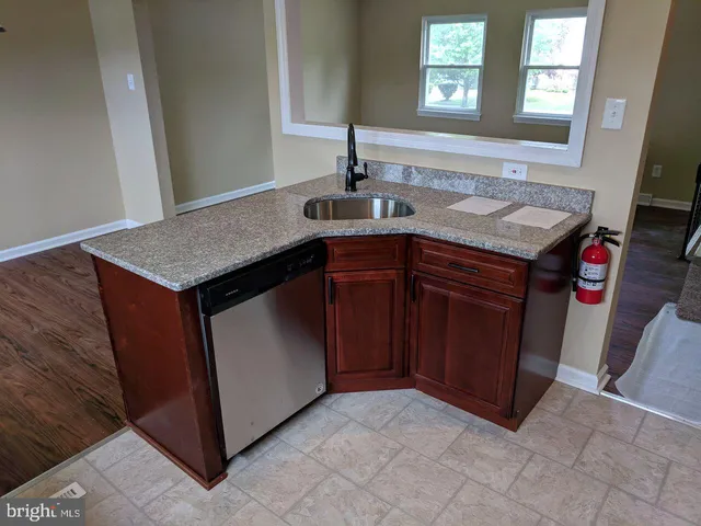 a kitchen with a sink and a mirror
