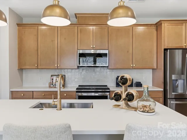 a kitchen with a sink a stove and cabinets