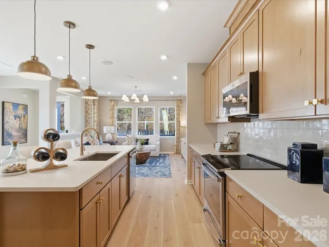 a kitchen with stainless steel appliances a sink stove and cabinets