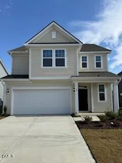 a front view of a house with garage and yard