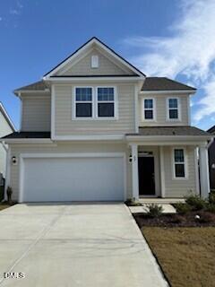 a front view of a house with garage and yard