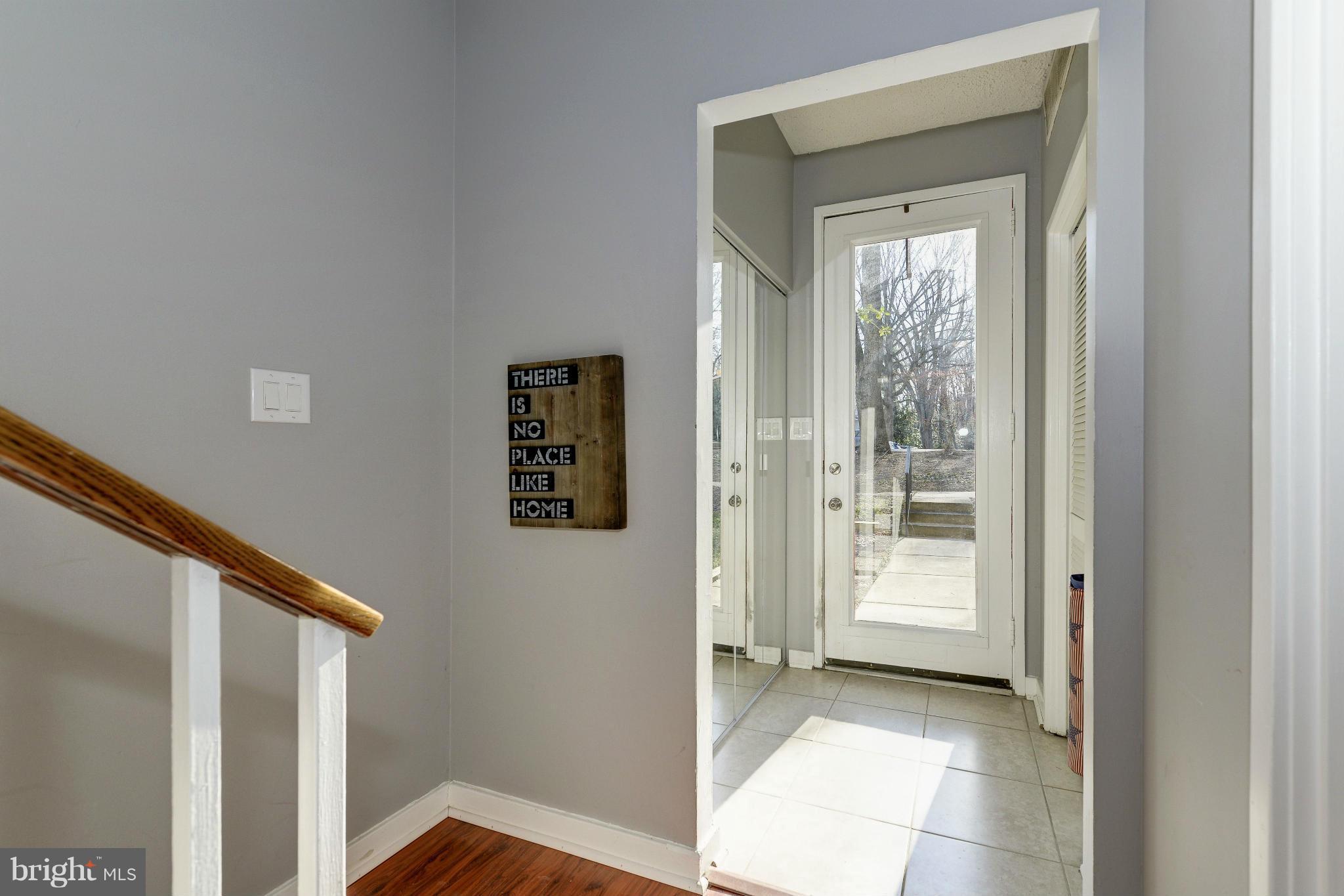 11475 Waterview Cluster Reston, VA 20190 - Photo 2 of 25 a view of a hallway with wooden floor and entryway