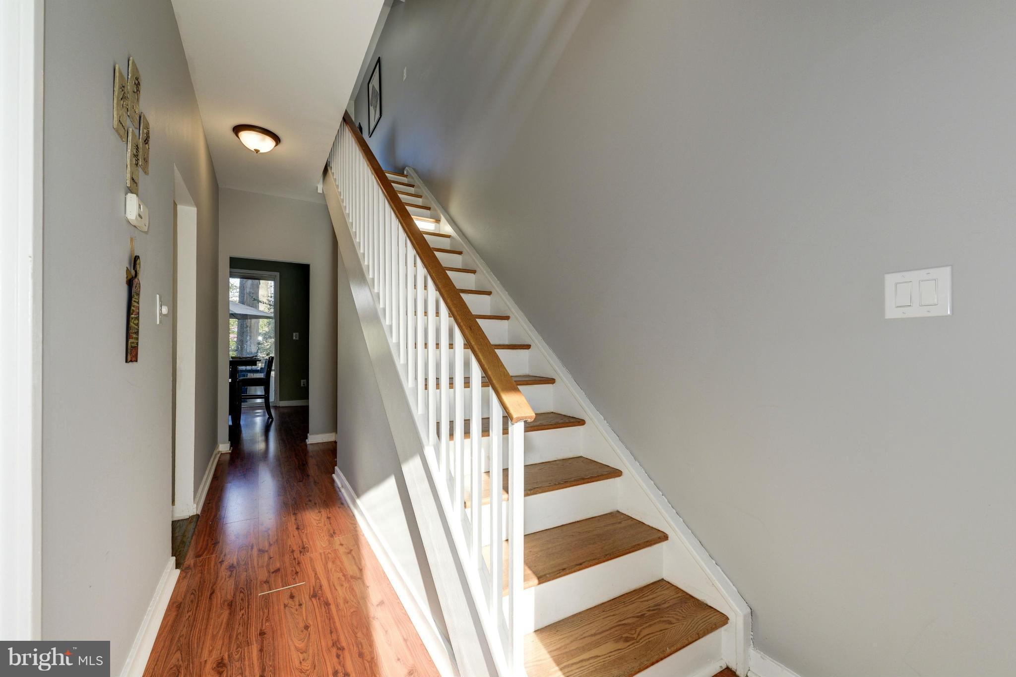 11475 Waterview Cluster Reston, VA 20190 - Photo 11 of 25 a view of a hallway with wooden floor and staircase