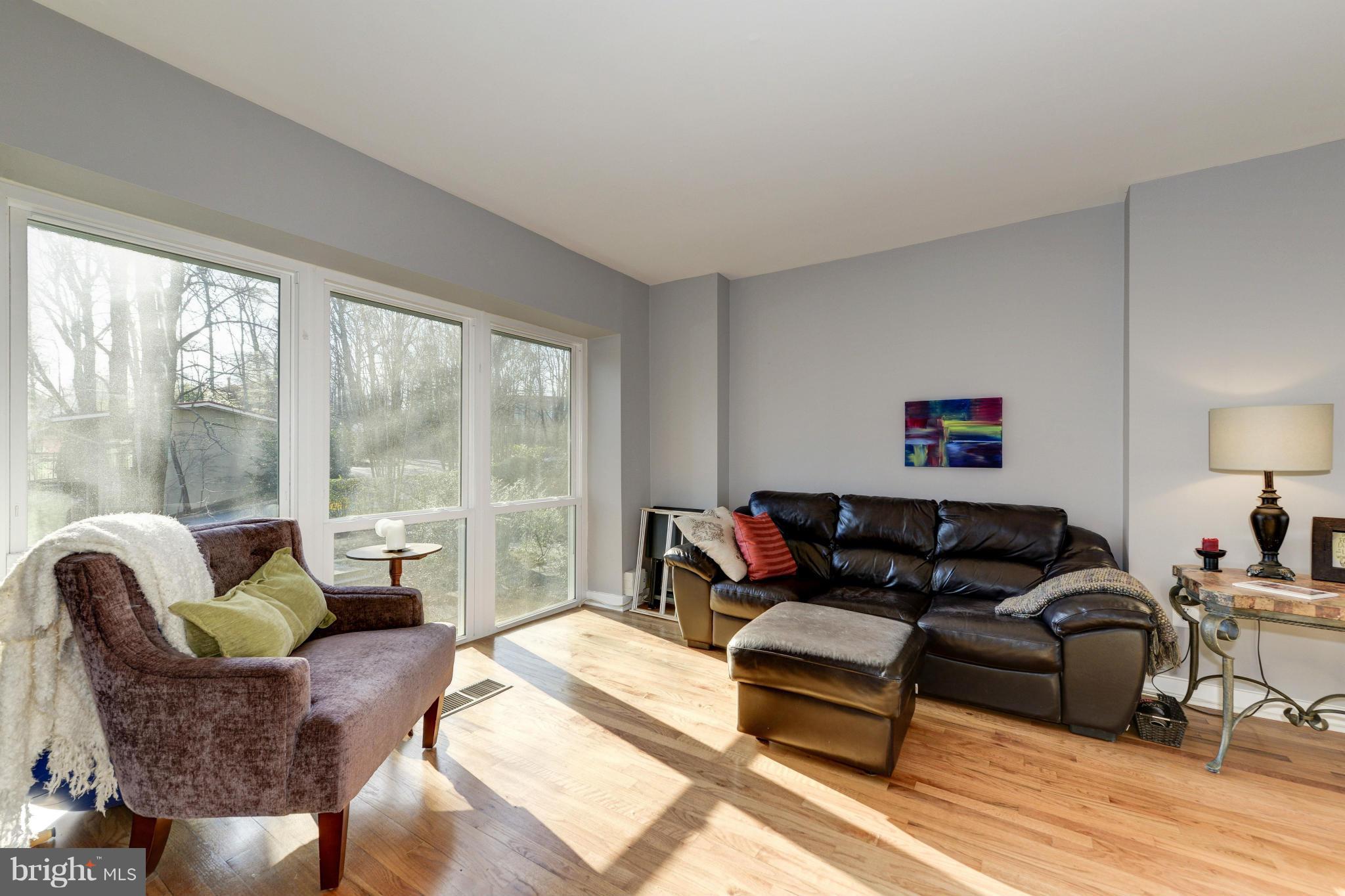 11475 Waterview Cluster Reston, VA 20190 - Photo 12 of 25 a living room with furniture and a large window