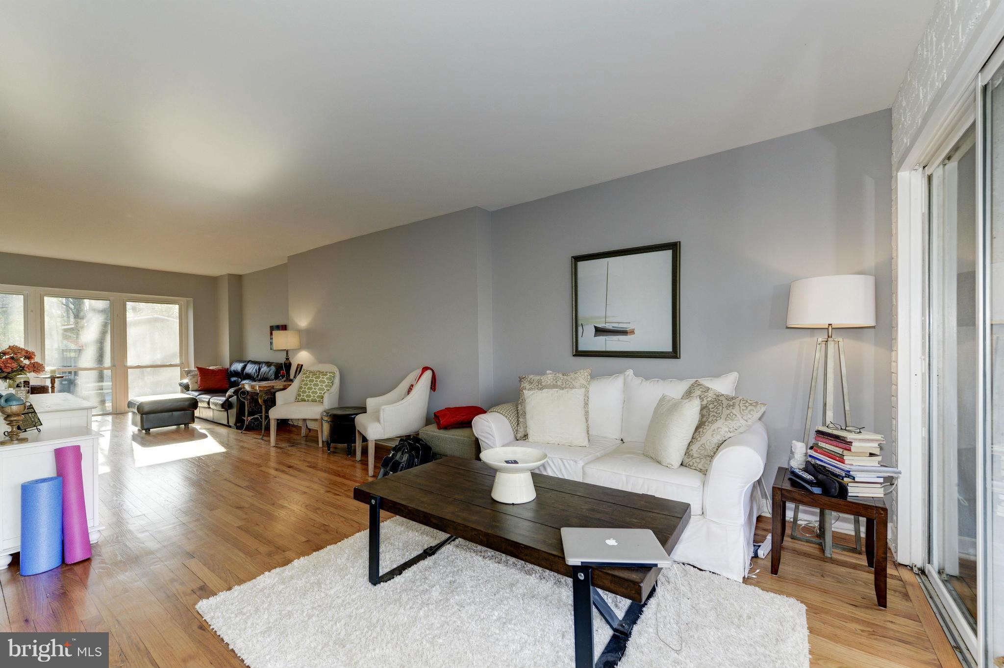 11475 Waterview Cluster Reston, VA 20190 - Photo 16 of 25 a living room with furniture and a wooden floor