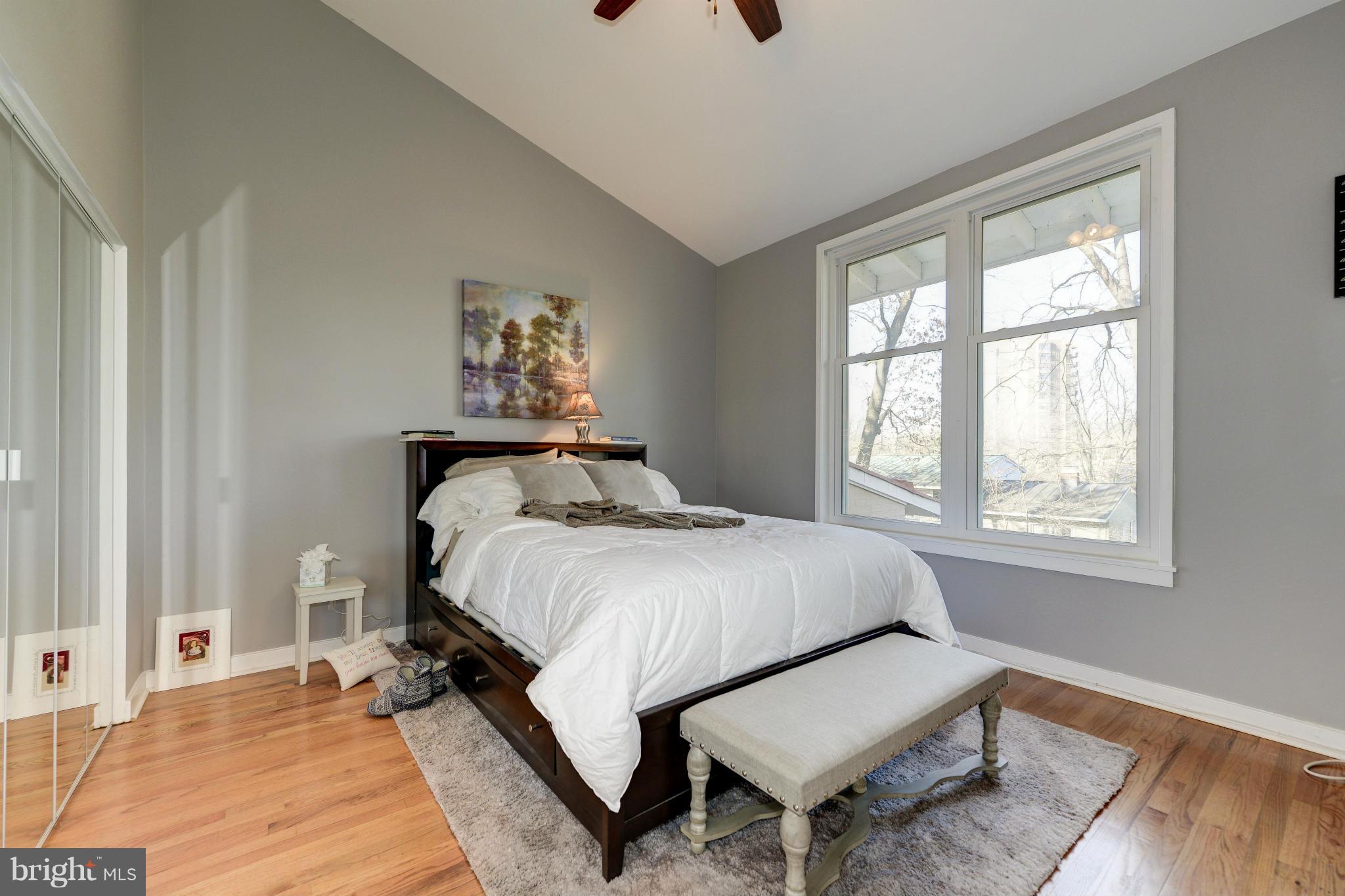 11475 Waterview Cluster Reston, VA 20190 - Photo 19 of 25 a bedroom with a bed and wooden floor