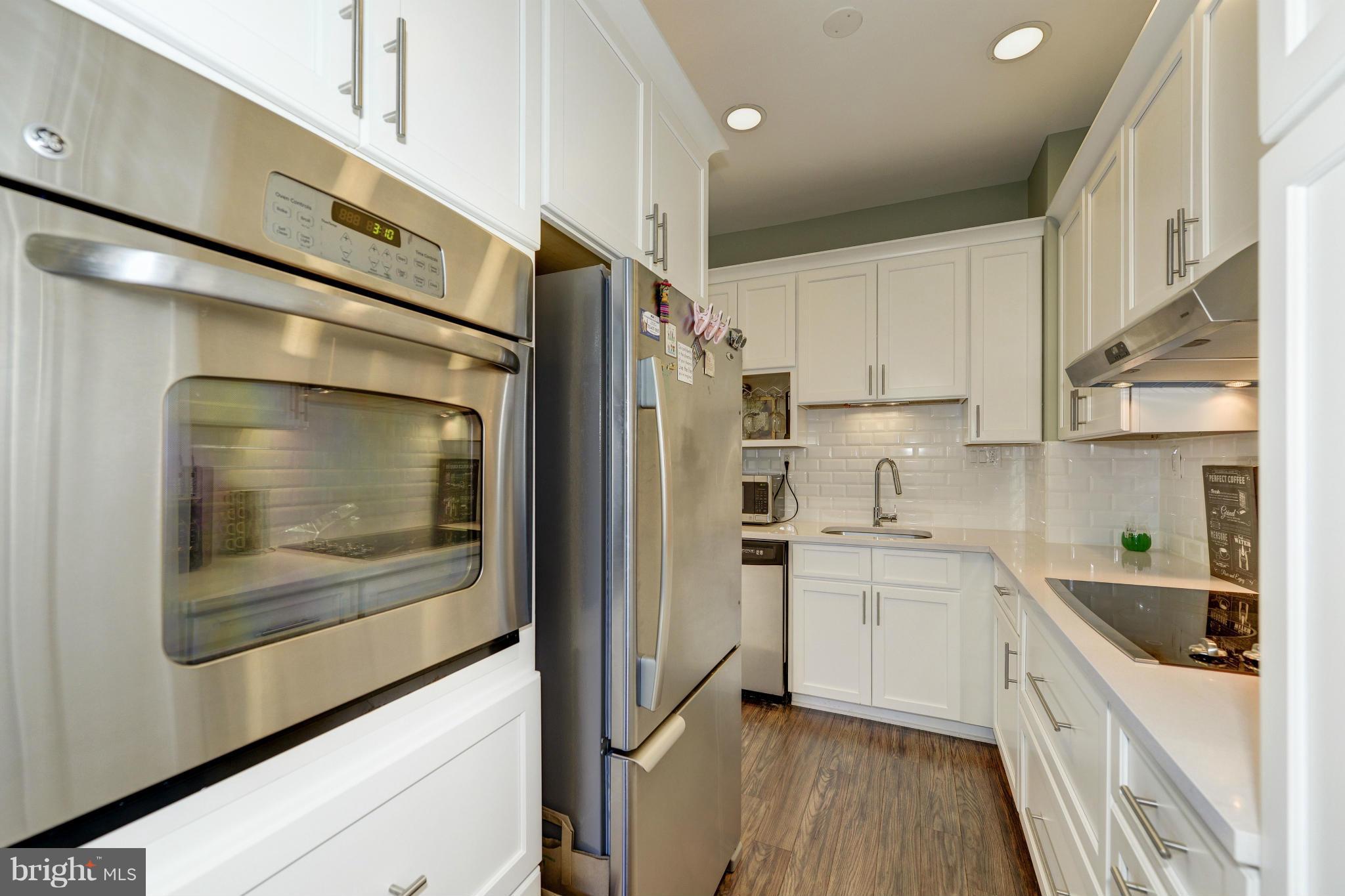 11475 Waterview Cluster Reston, VA 20190 - Photo 3 of 25 a kitchen with stainless steel appliances a refrigerator sink and cabinets