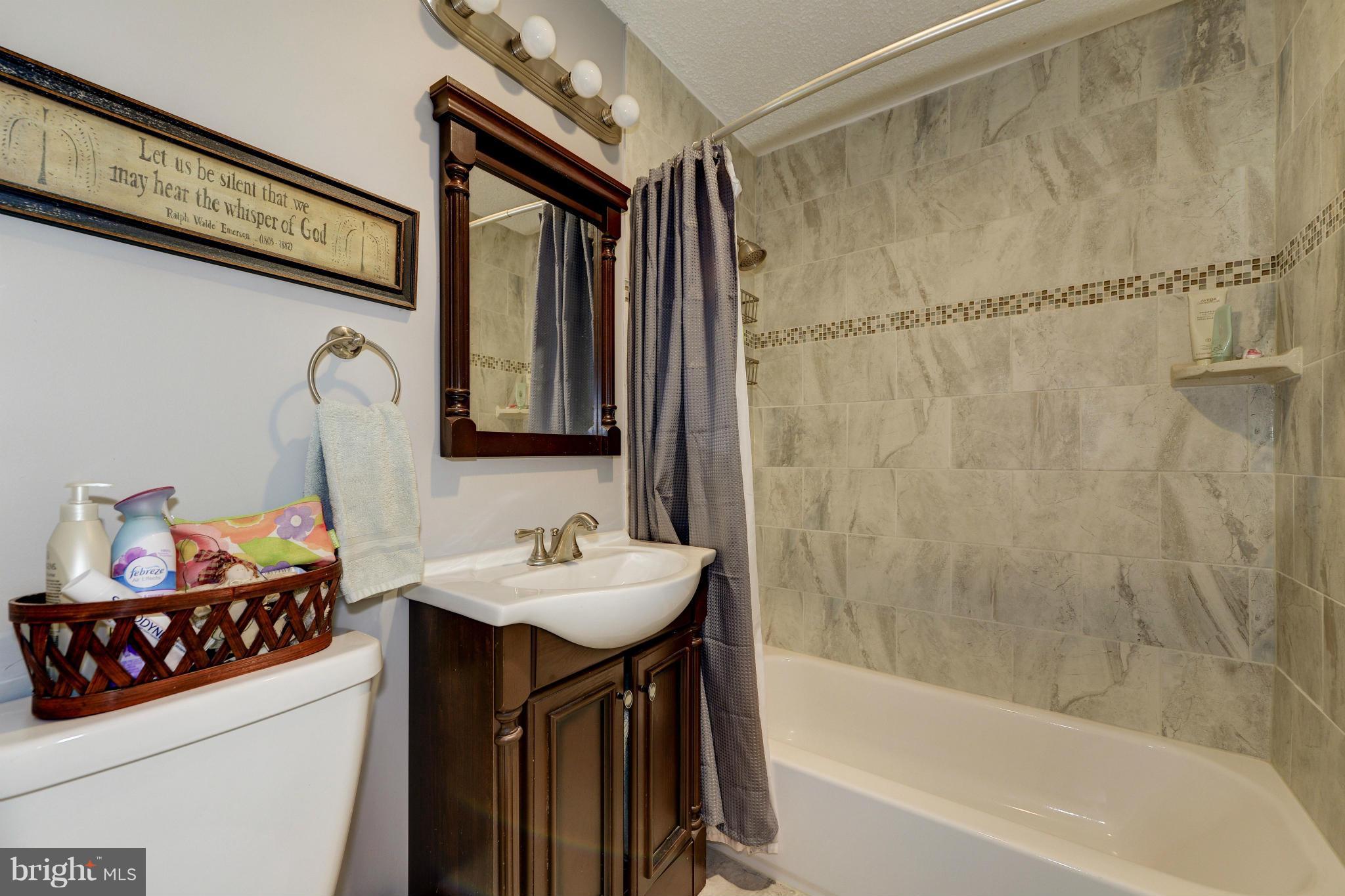 11475 Waterview Cluster Reston, VA 20190 - Photo 22 of 25 a bathroom with a sink mirror toilet and bathtub
