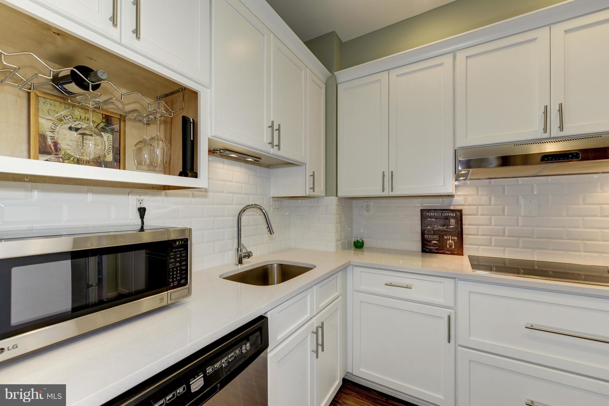 11475 Waterview Cluster Reston, VA 20190 - Photo 5 of 25 a kitchen with stainless steel appliances white cabinets and a sink