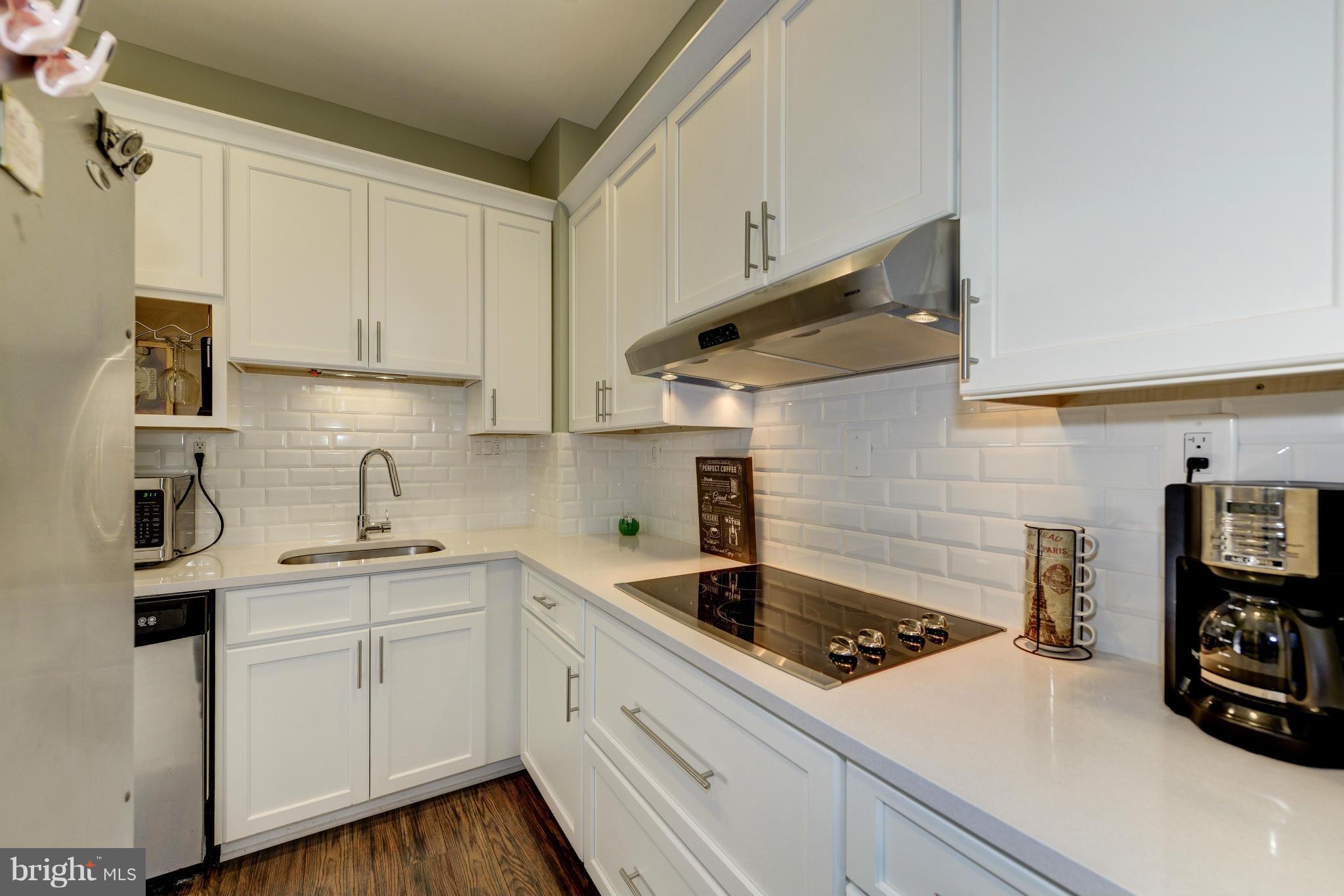 11475 Waterview Cluster Reston, VA 20190 - Photo 6 of 25 a kitchen with a sink a stove and cabinets