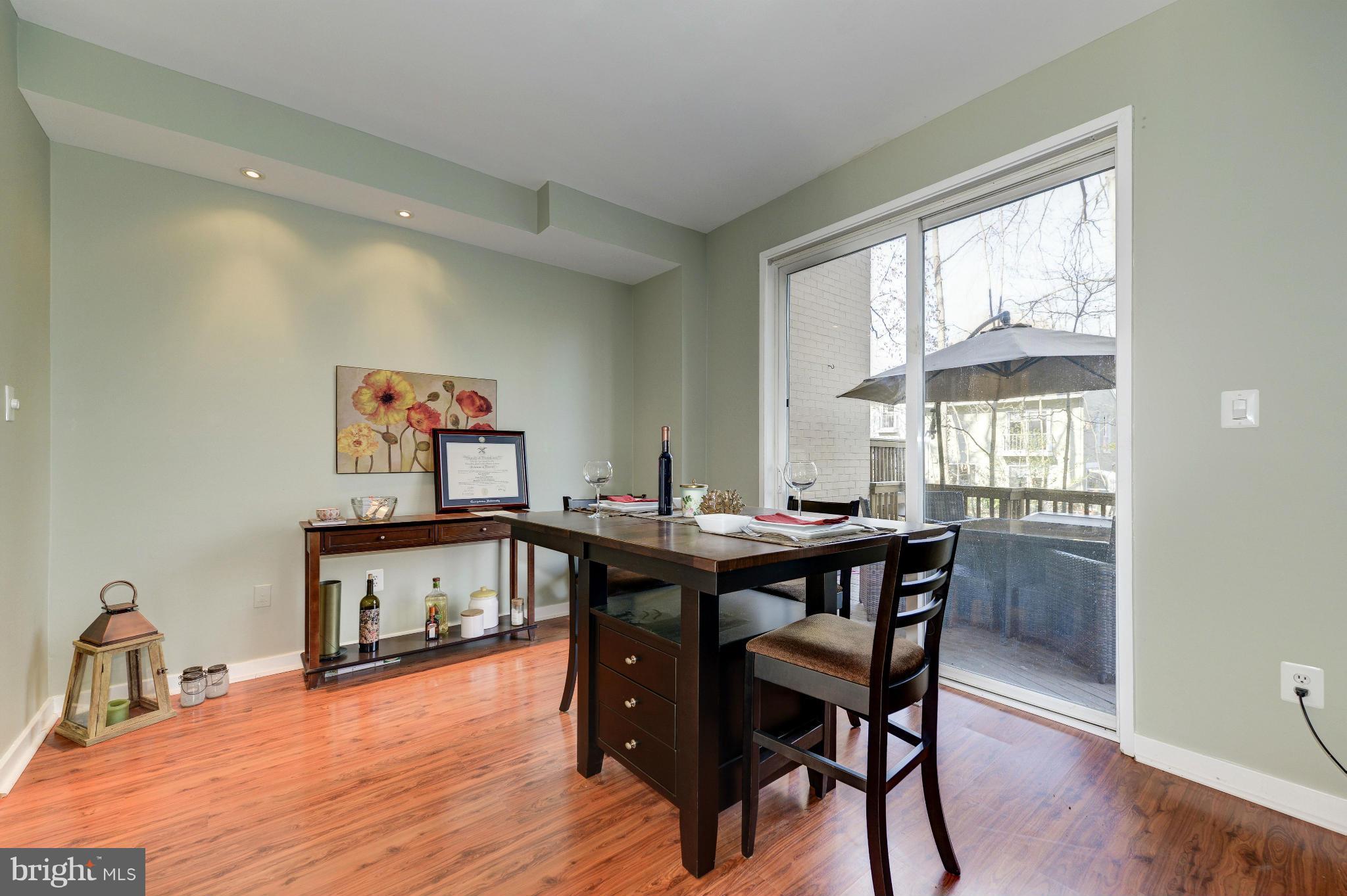 11475 Waterview Cluster Reston, VA 20190 - Photo 8 of 25 a view of a dining room with furniture window and wooden floor