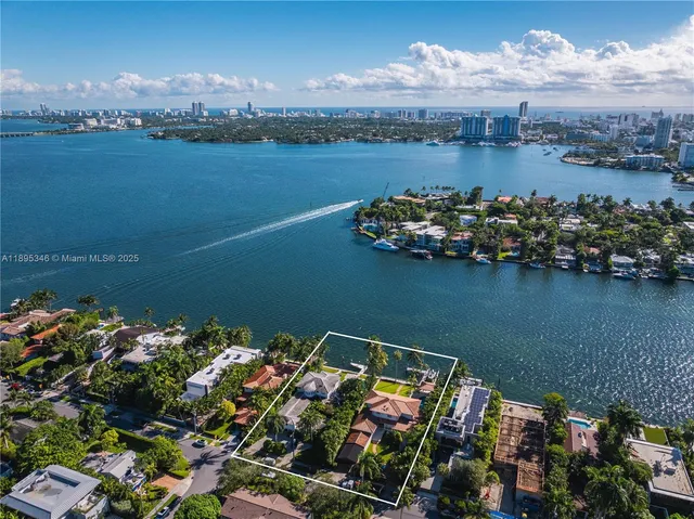 an aerial view of a house with a lake view