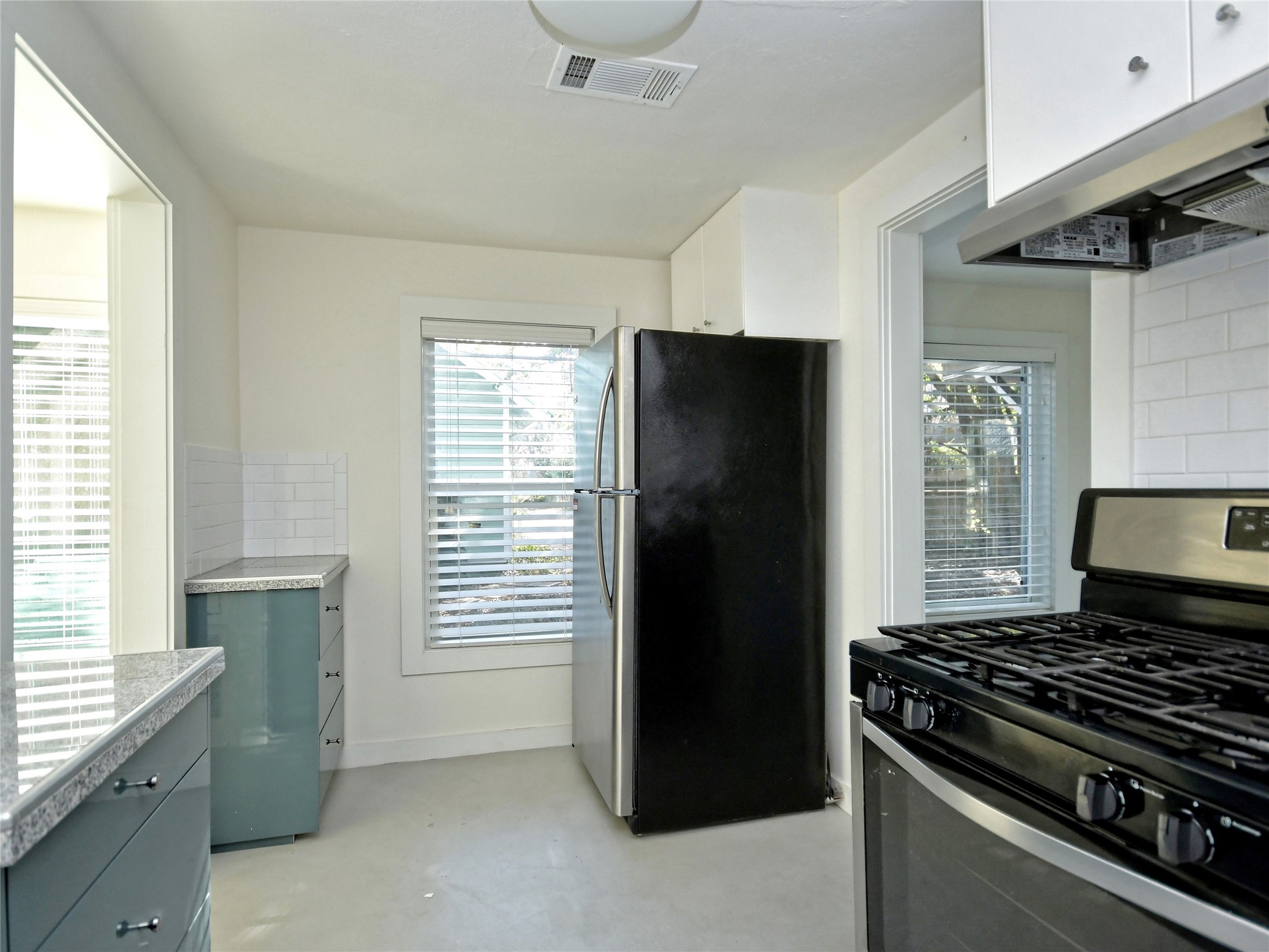 4604 Red River Street, Unit B Austin, TX 78751 - Photo 10 of 15 A compact kitchen with granite counters and efficient appliances, perfect for urban living.