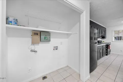 a view of a room with wooden floor and chandelier