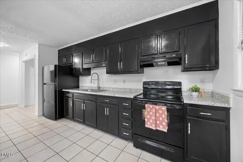 a kitchen with stainless steel appliances granite countertop a refrigerator sink and cabinets