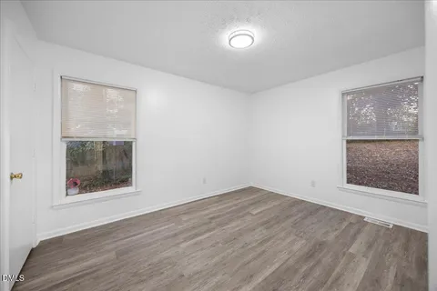 a kitchen with a sink window and cabinets