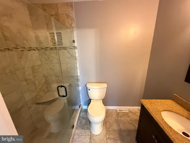 a bathroom with a toilet and a shower