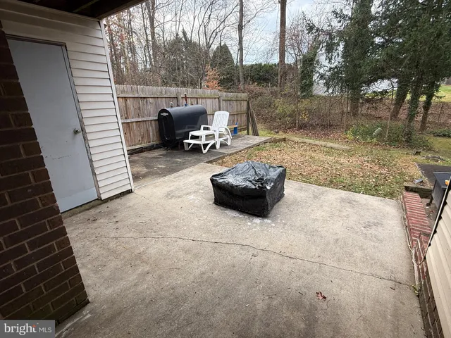 a view of backyard with seating area and trees