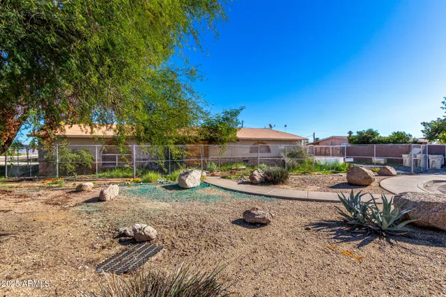 a view of a backyard with table and chairs under an umbrella
