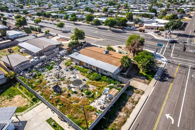 an aerial view of a residential houses with yard