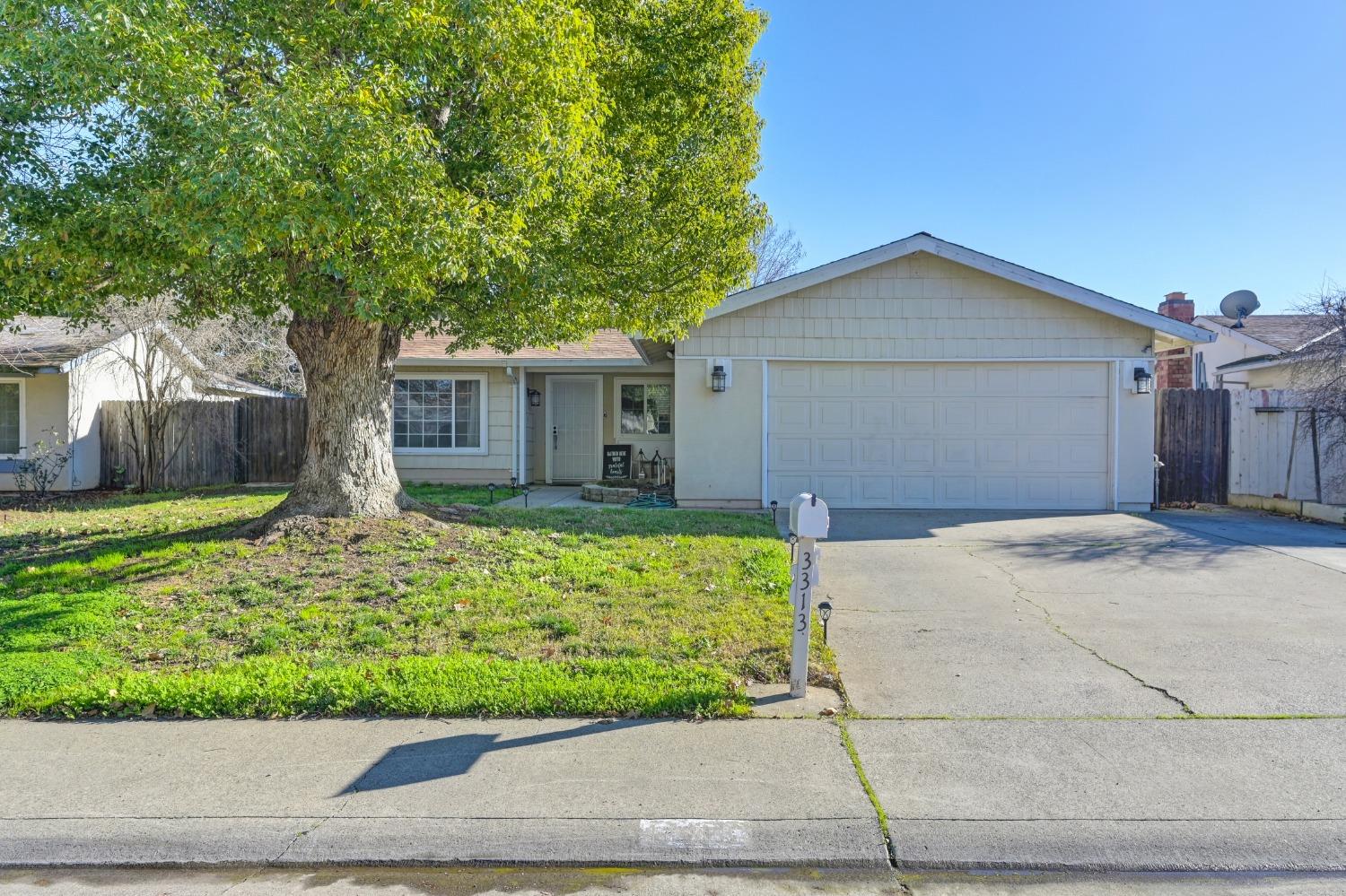 a front view of house with garage and yard