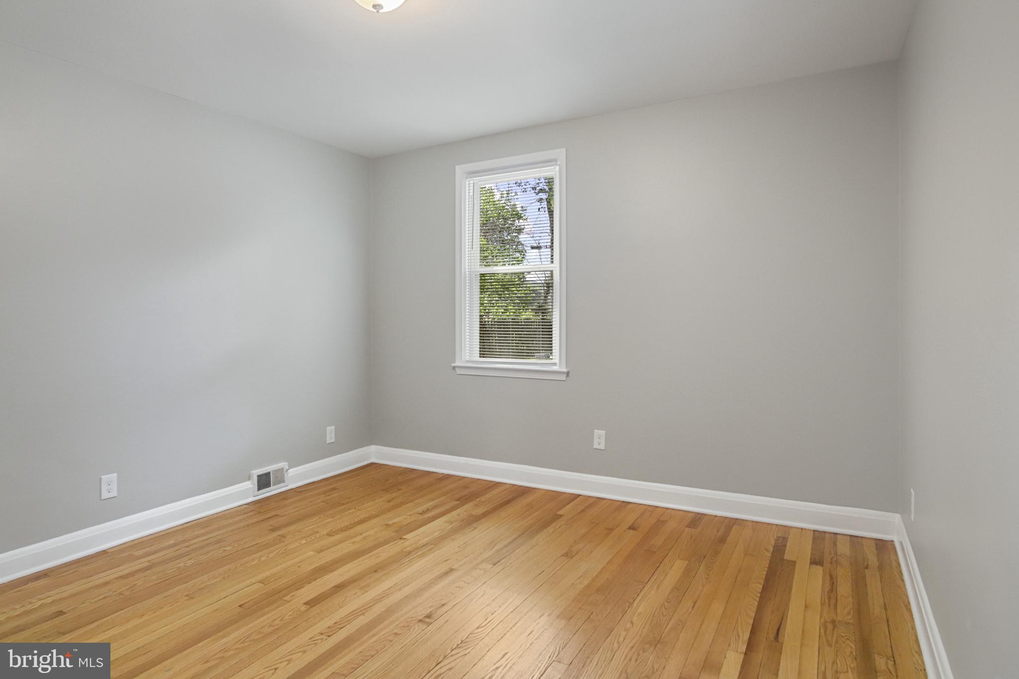 608 Farmhurst Road Baltimore, MD 21208 - Photo 18 of 45 a view of a room with wooden floor and windows