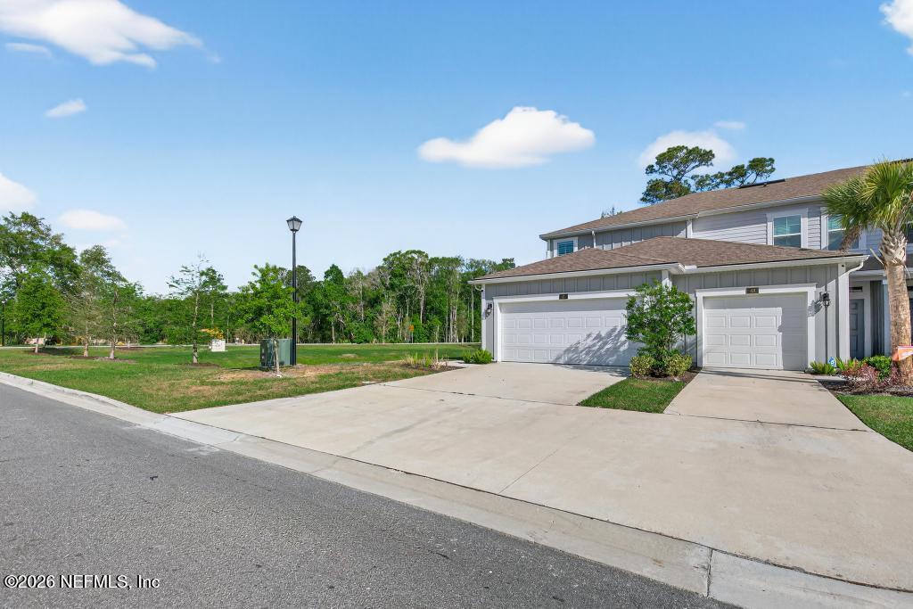 45 Seaport Breeze Road St. Augustine, FL 32095 - Photo 4 of 88 a front view of a house with a yard and a garage