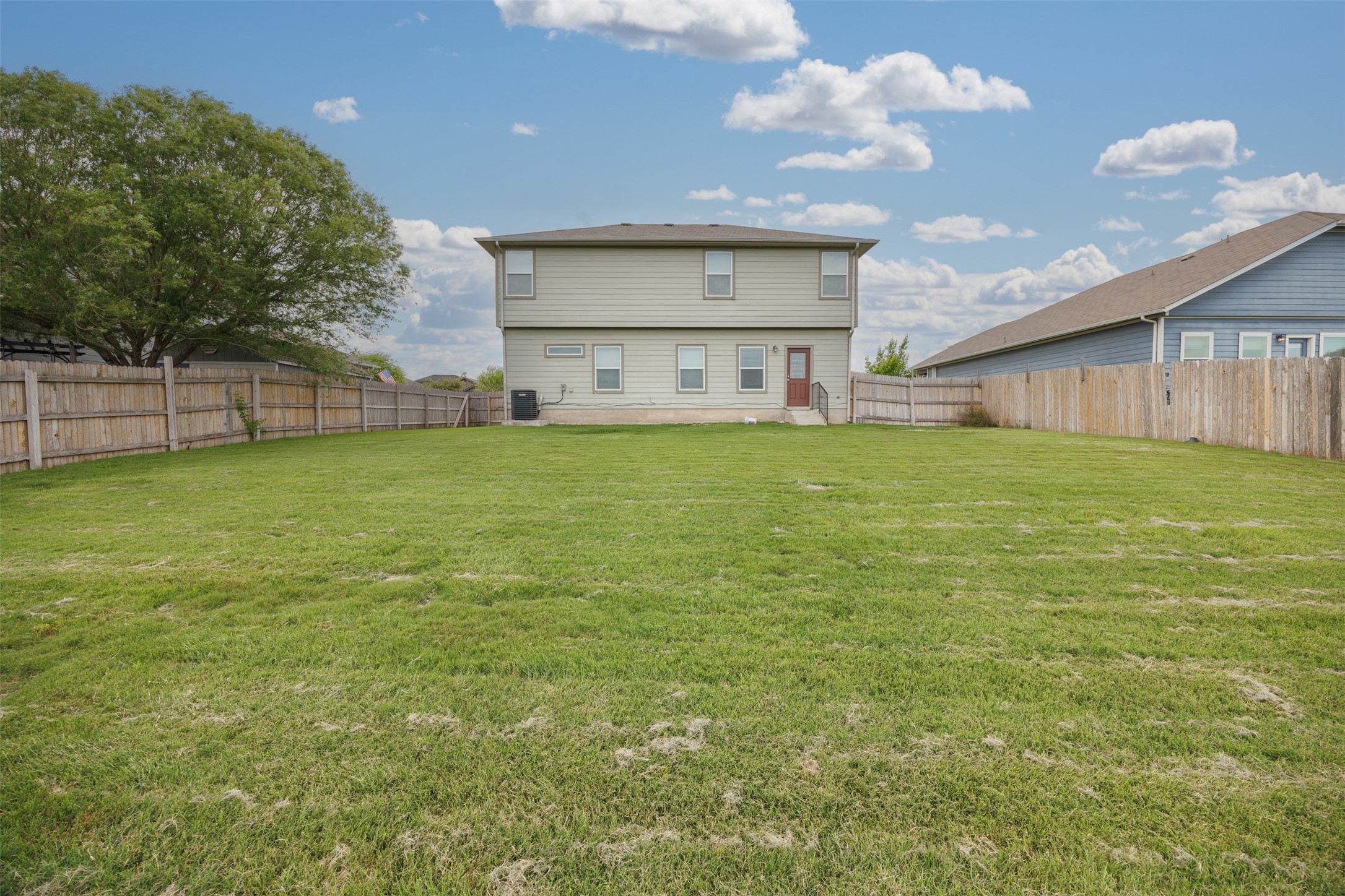 703 Liard River Road Hutto, TX 78634 - Photo 16 of 16 A vast, level green yard with privacy fencing frames the back of this two-story residence.