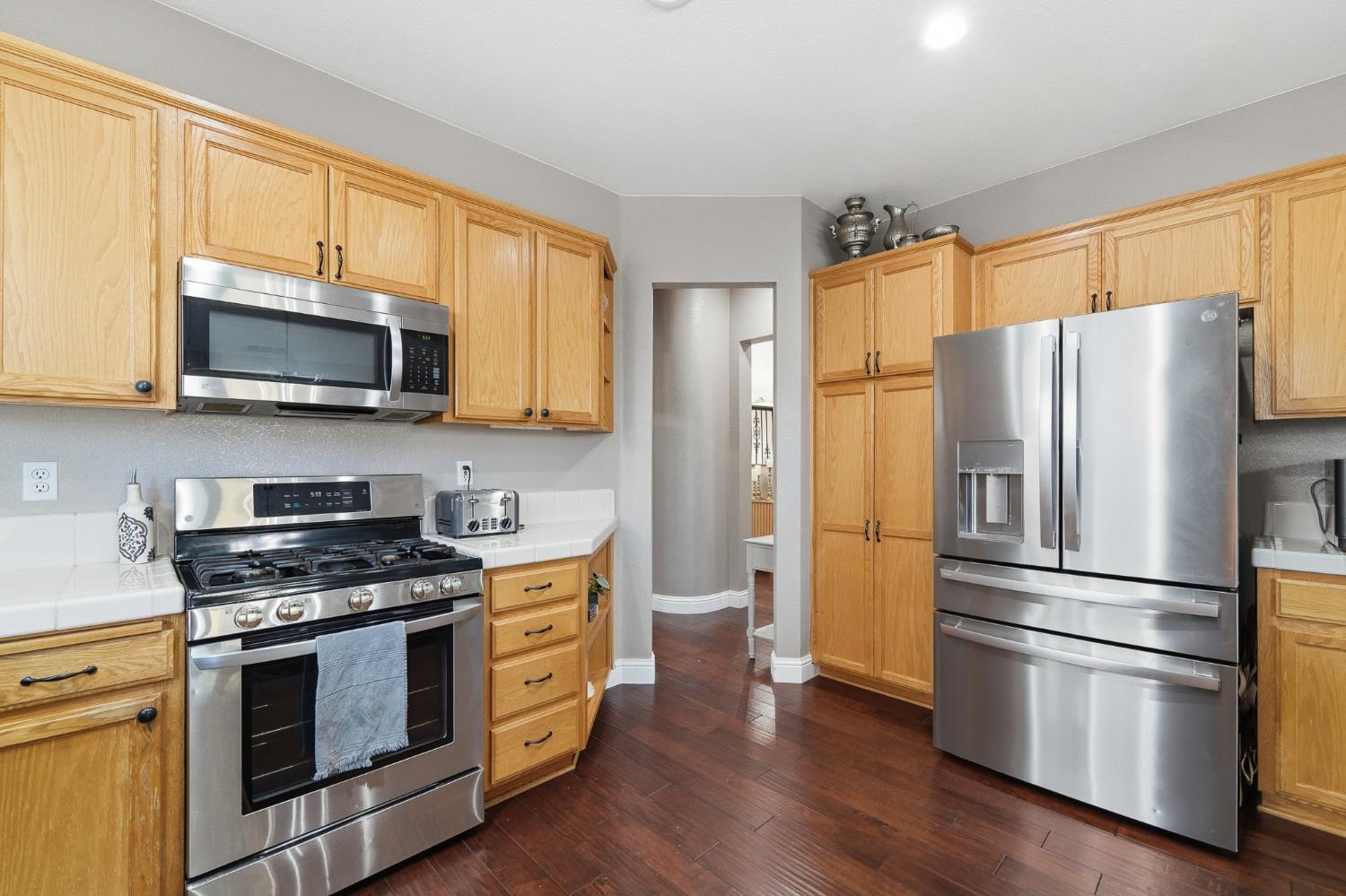 2220 Ellison Drive Modesto, CA 95355 - Photo 12 of 53 a kitchen with stainless steel appliances a refrigerator microwave and sink