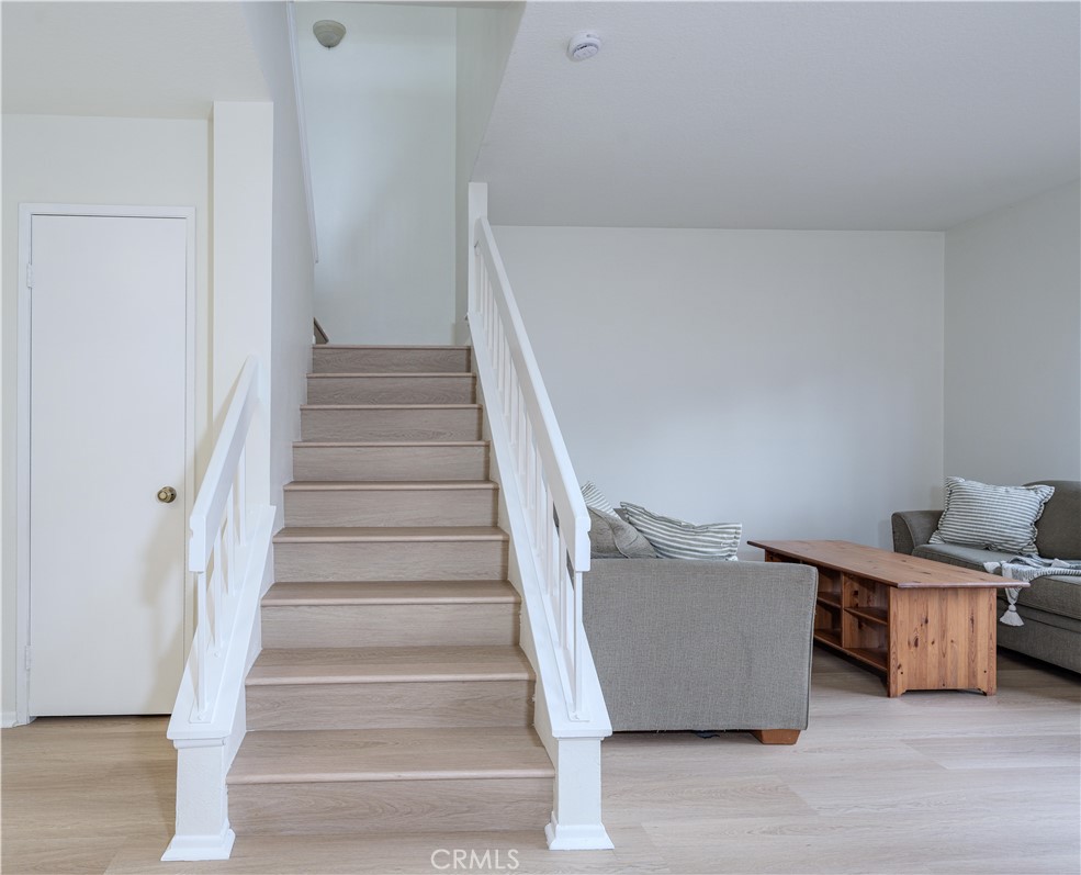 305 Huntington Irvine, CA 92620 - Photo 14 of 35 a view of a livingroom with wooden floor and stairs
