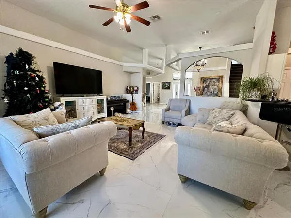 a living room with furniture and a wooden floor