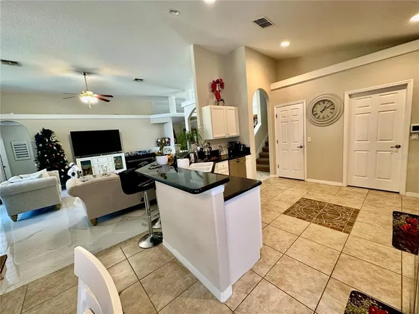 a kitchen with stainless steel appliances kitchen island granite countertop a refrigerator and a stove top oven