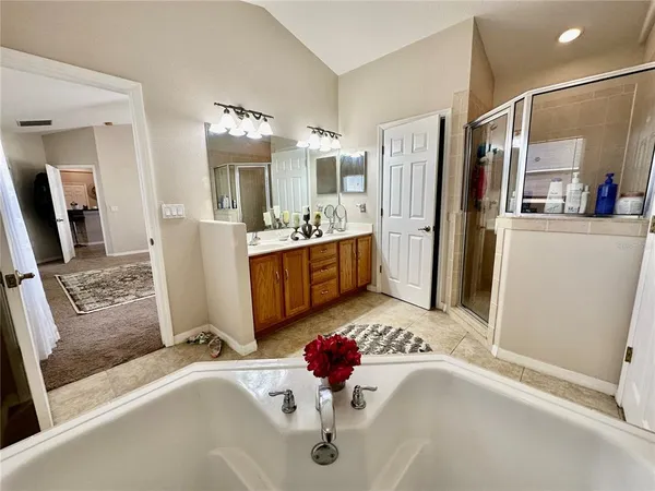 a bathroom with a double vanity sink a mirror and a shower