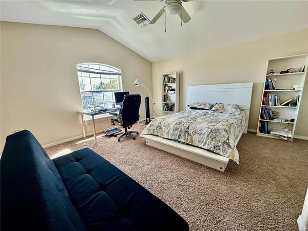 a living room with furniture and a floor to ceiling window