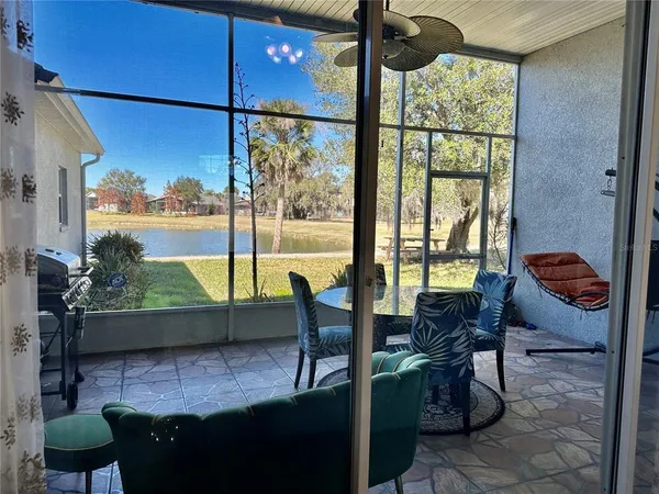 a view of a porch with chairs and a yard