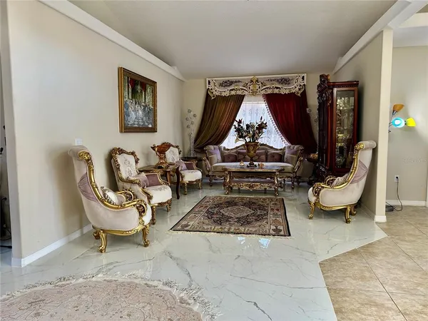 a view of a dining room with furniture and chandelier
