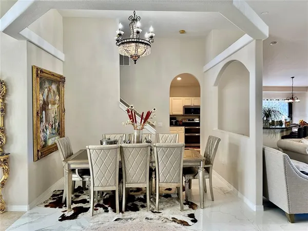 a view of a living room with furniture and wooden floor