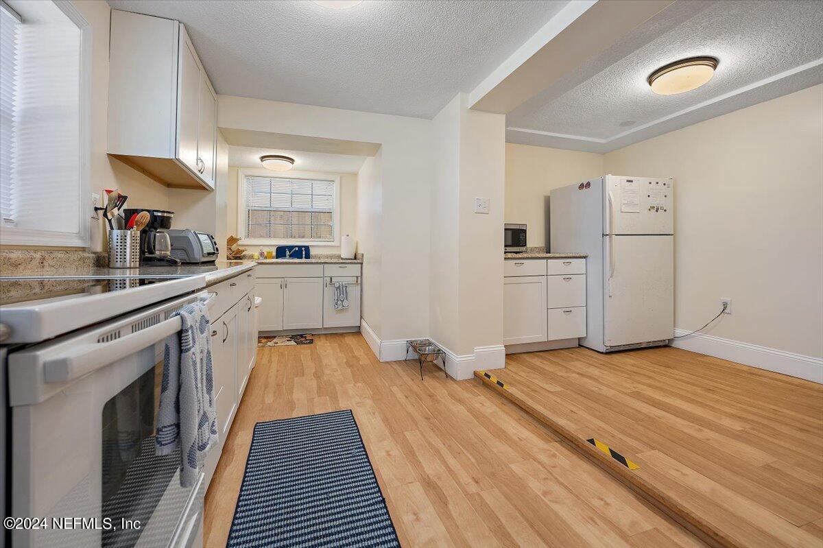 2610 Pacetti Road, Unit A St. Augustine, FL 32092 - Photo 11 of 31 a kitchen with a sink stove and refrigerator