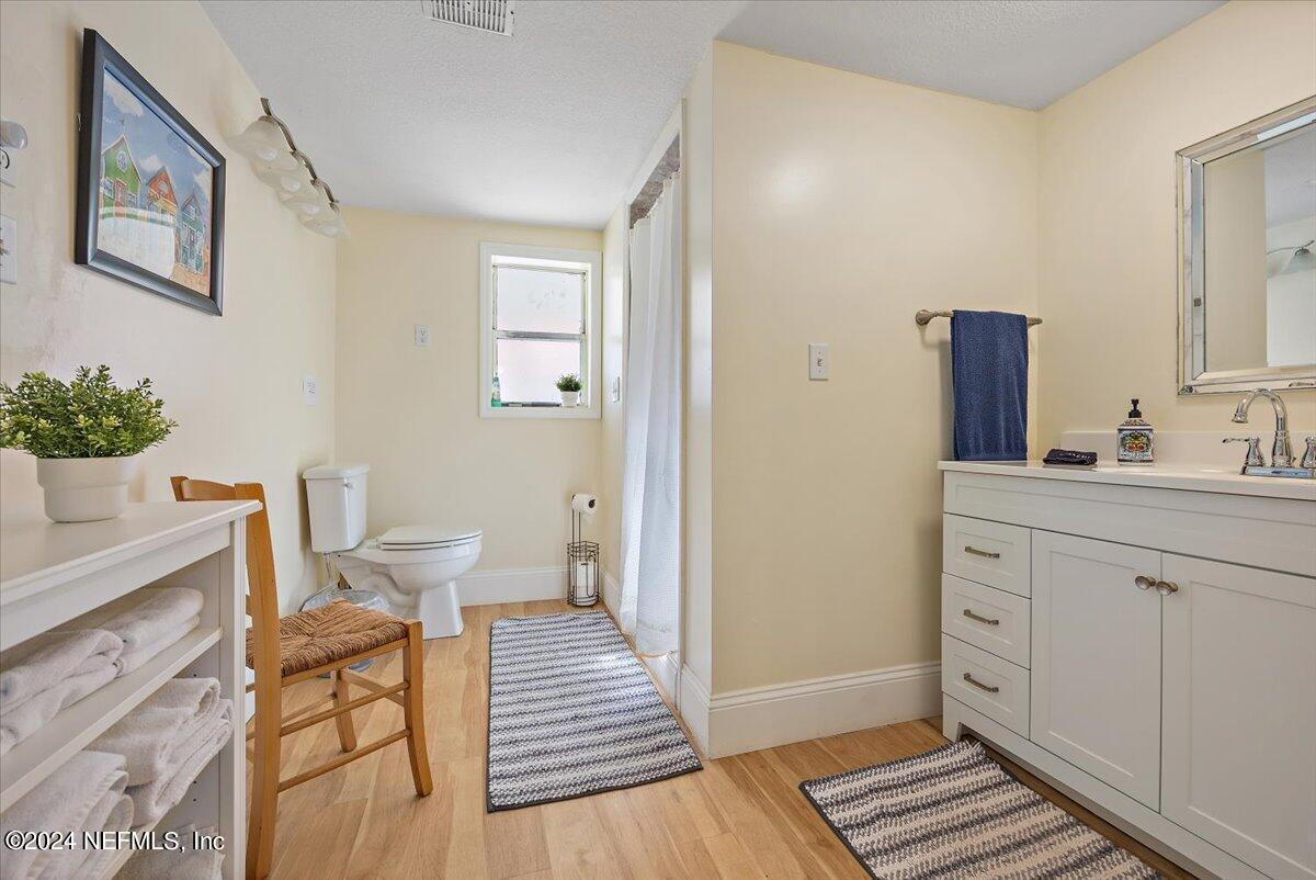 2610 Pacetti Road, Unit A St. Augustine, FL 32092 - Photo 13 of 31 a spacious bathroom with a toilet a sink and mirror