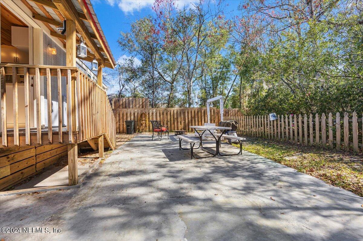 2610 Pacetti Road, Unit A St. Augustine, FL 32092 - Photo 18 of 31 a view of backyard with a chair and table in the patio