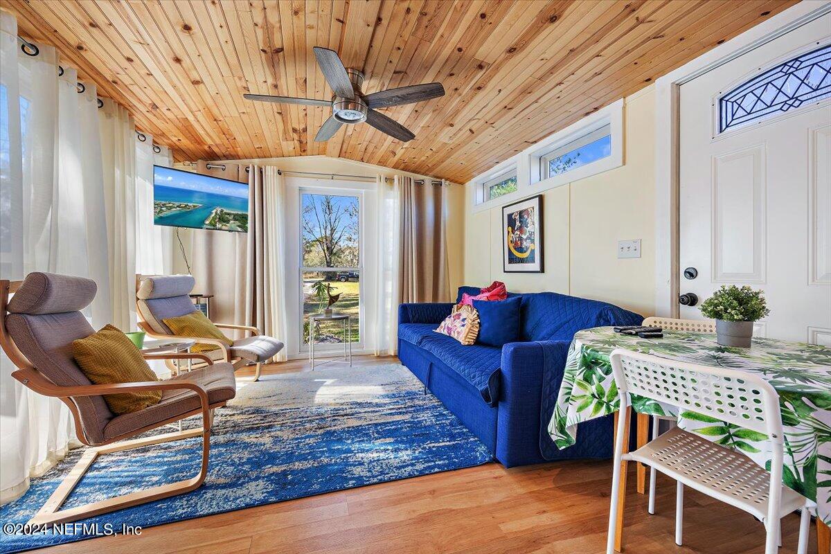 2610 Pacetti Road, Unit A St. Augustine, FL 32092 - Photo 19 of 31 a living room with furniture a wooden floor and next to a window