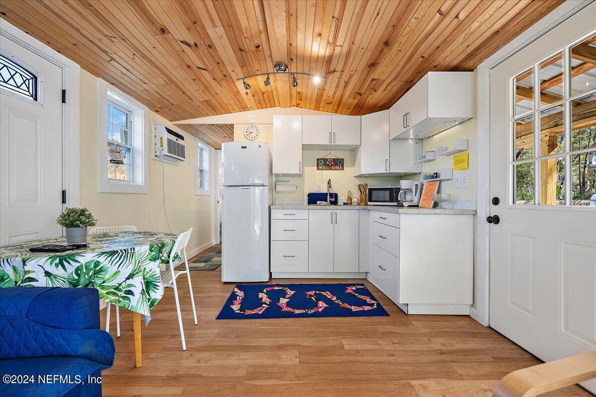 2610 Pacetti Road, Unit A St. Augustine, FL 32092 - Photo 20 of 31 a kitchen with stainless steel appliances a white refrigerator a stove a sink and a potted plant