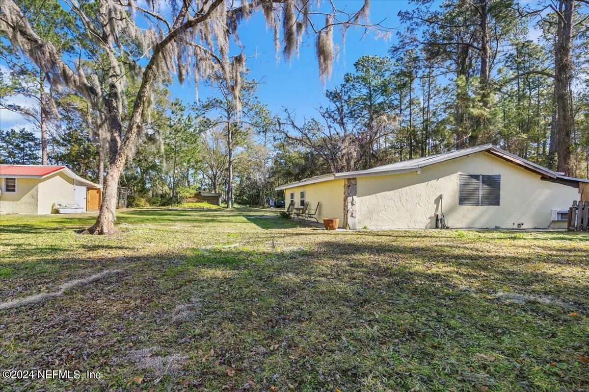 2610 Pacetti Road, Unit A St. Augustine, FL 32092 - Photo 26 of 31 a front view of house with yard and trees