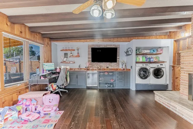 a living room with a fireplace furniture and a flat screen tv