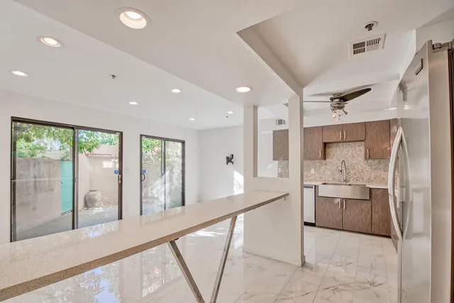 a large white kitchen with a large window