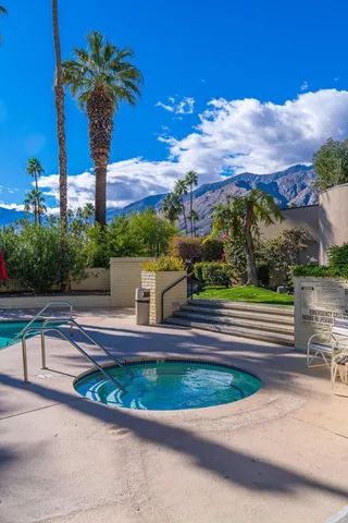 a vase of flowers sitting on a table in a patio